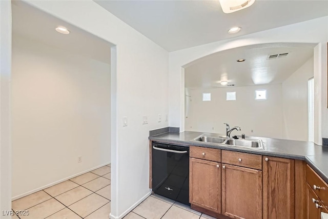 kitchen with light tile patterned flooring, black dishwasher, and sink