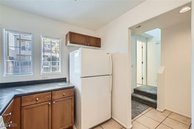 kitchen featuring light tile patterned floors and white refrigerator