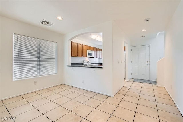 kitchen with light tile patterned flooring and range