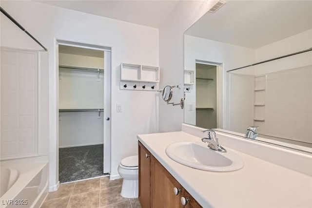 full bathroom with washtub / shower combination, vanity, toilet, and tile patterned flooring