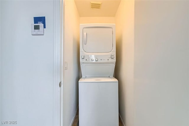 laundry room with stacked washing maching and dryer