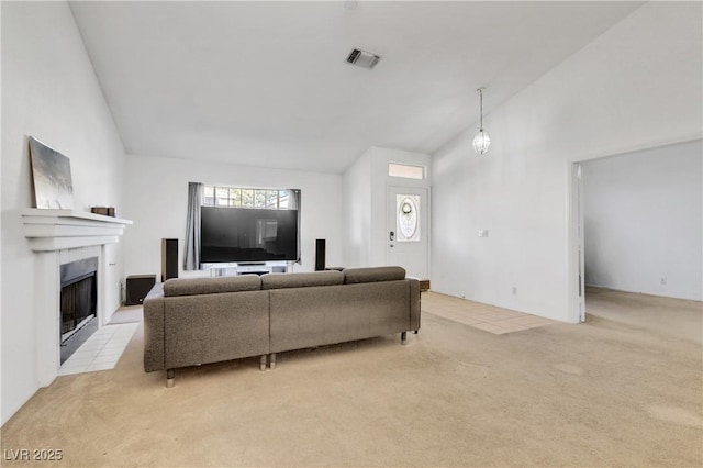 carpeted living room featuring high vaulted ceiling