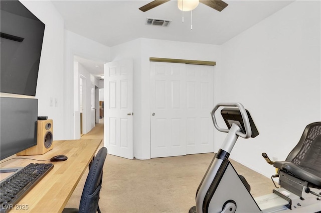 exercise room featuring light carpet and ceiling fan