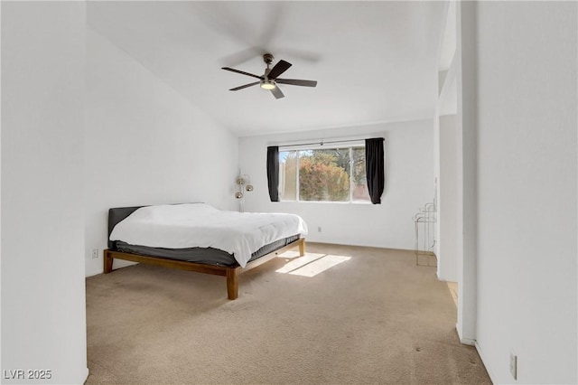 bedroom with ceiling fan, vaulted ceiling, and light carpet