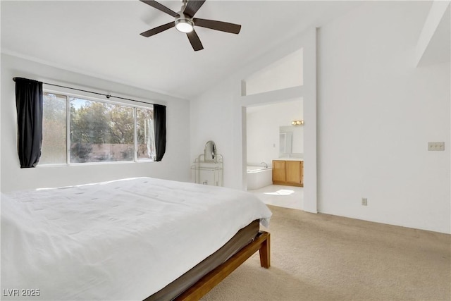 bedroom with ceiling fan, light colored carpet, lofted ceiling, and ensuite bathroom