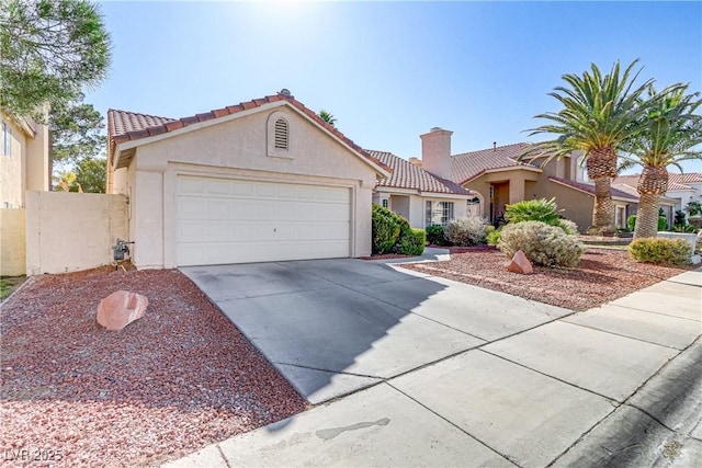 mediterranean / spanish-style home with a garage