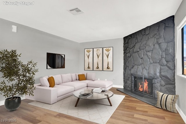 living room with a fireplace and light hardwood / wood-style flooring