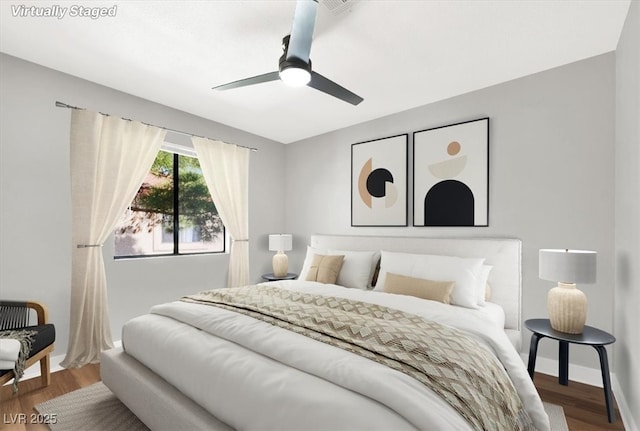 bedroom with ceiling fan and wood-type flooring