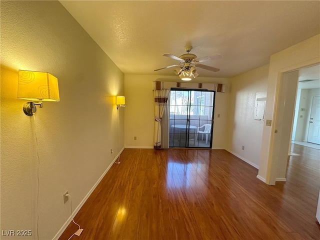 unfurnished room featuring hardwood / wood-style floors and ceiling fan