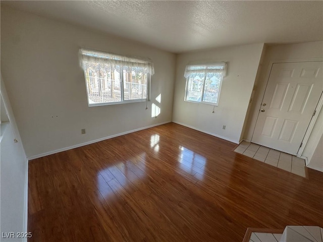 interior space with hardwood / wood-style flooring and a textured ceiling