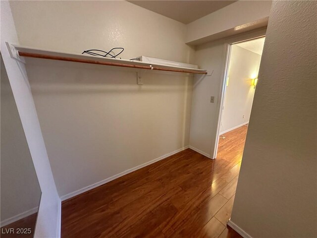 spacious closet featuring hardwood / wood-style floors