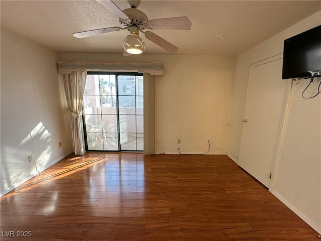 unfurnished room featuring hardwood / wood-style floors and ceiling fan