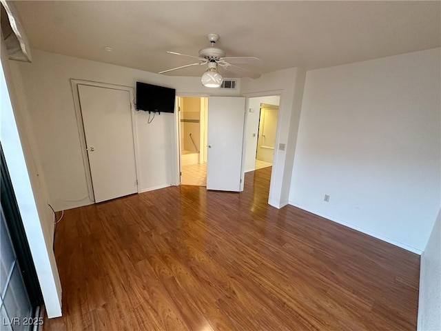 unfurnished bedroom featuring hardwood / wood-style flooring, ceiling fan, and a closet