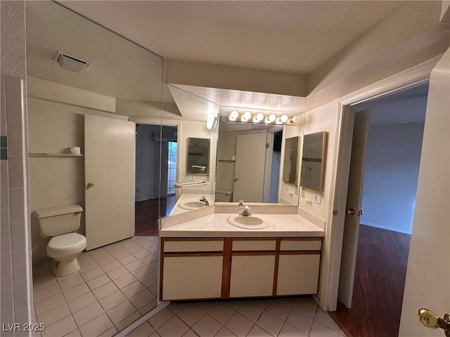 bathroom with vanity, tile patterned floors, and toilet