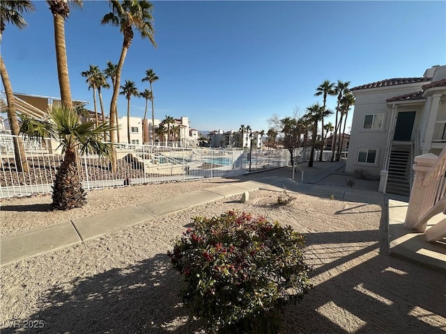 view of yard featuring a community pool and a patio area