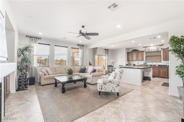 living room with light tile patterned flooring and ceiling fan