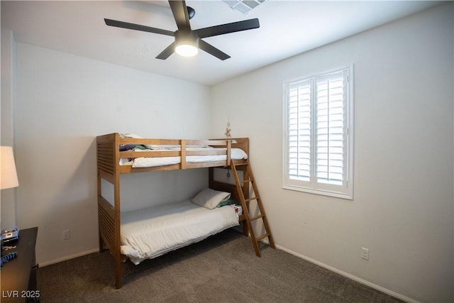 bedroom with dark colored carpet and ceiling fan