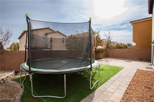 view of yard with a patio and a trampoline