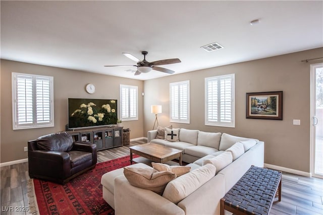 living room featuring hardwood / wood-style flooring and ceiling fan