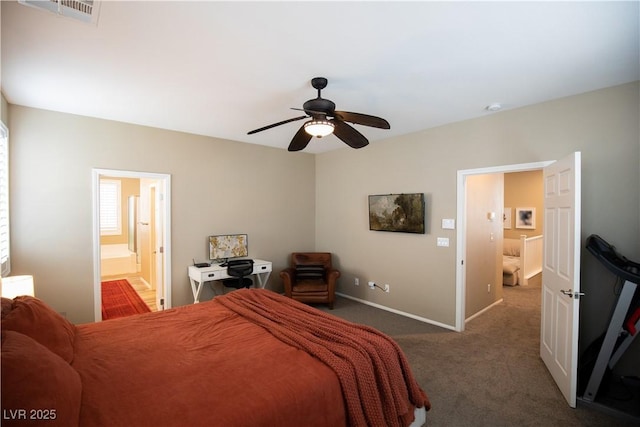 bedroom with ceiling fan, ensuite bath, and dark colored carpet