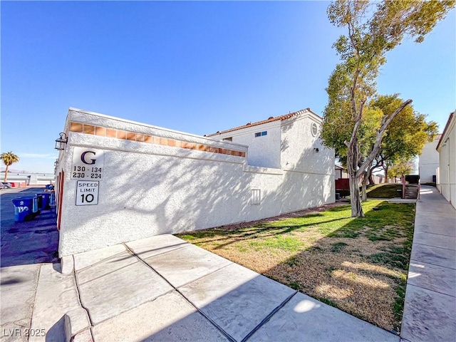 view of property exterior with a lawn