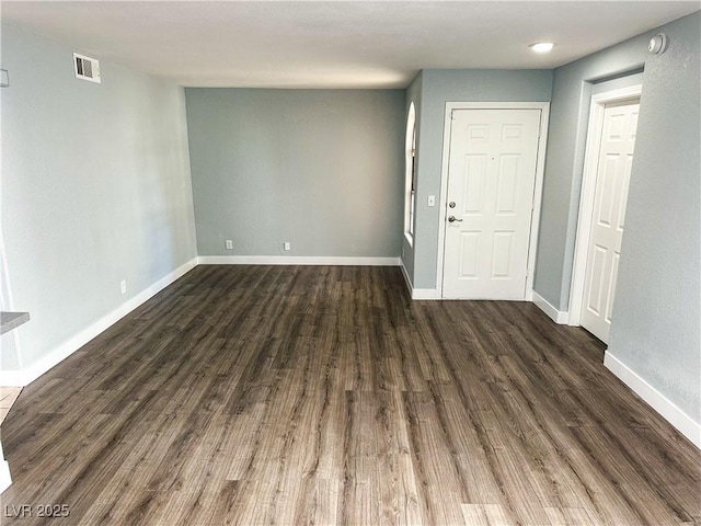 spare room with dark wood-type flooring