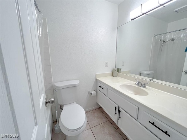 bathroom featuring a shower with shower curtain, vanity, toilet, and tile patterned flooring