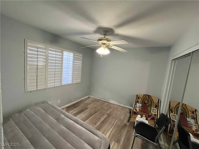 bedroom with ceiling fan, hardwood / wood-style floors, and a closet