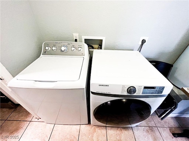 laundry area featuring tile patterned flooring and washer / dryer