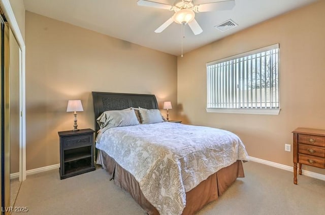 bedroom with a closet, light colored carpet, and ceiling fan