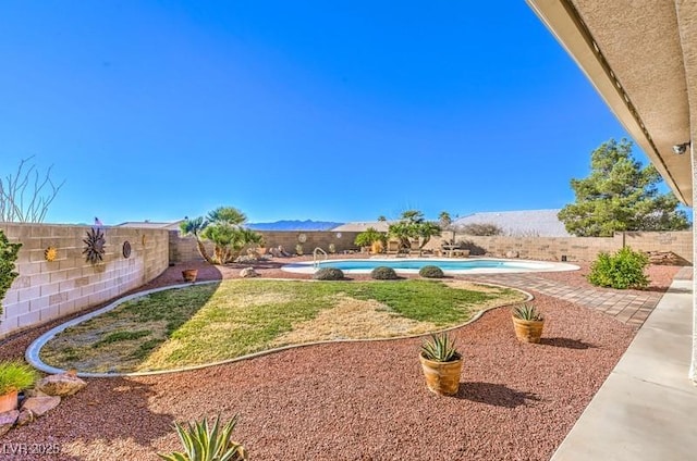 view of yard featuring a mountain view and a fenced in pool