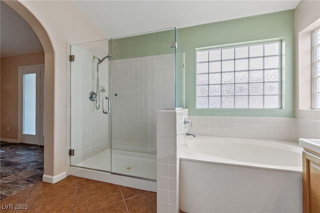 bathroom with shower with separate bathtub, tile patterned floors, and vanity