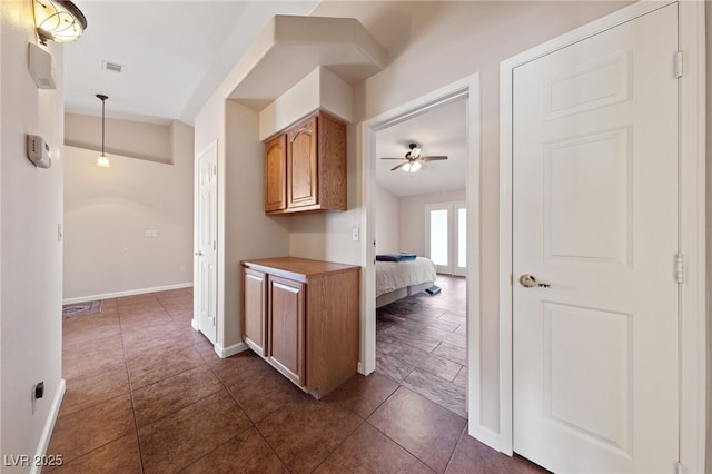 kitchen featuring ceiling fan, lofted ceiling, and decorative light fixtures