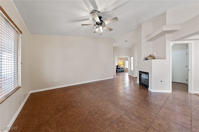 unfurnished living room with tile patterned flooring, vaulted ceiling, and ceiling fan