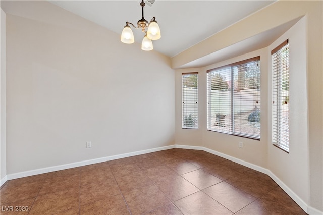 tiled empty room featuring lofted ceiling and a notable chandelier