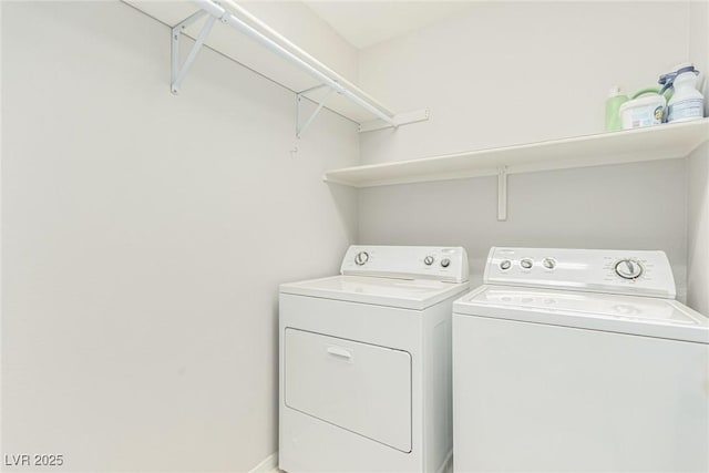 washroom with washing machine and clothes dryer