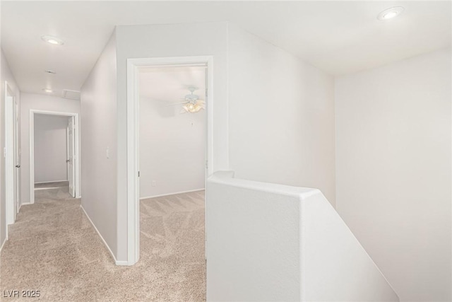 hallway featuring light colored carpet