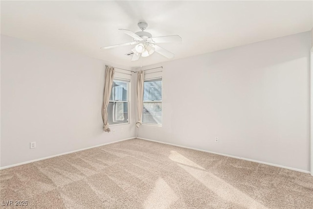 empty room featuring carpet flooring and ceiling fan