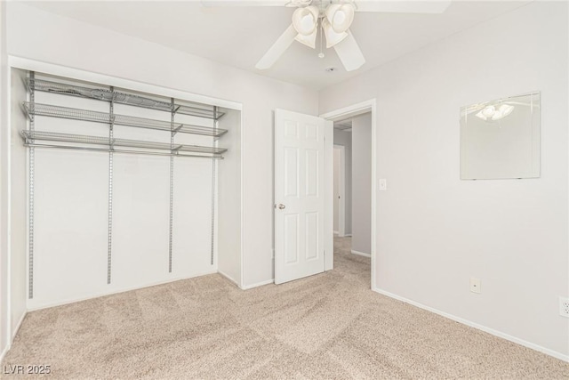 unfurnished bedroom with ceiling fan, light carpet, and a closet