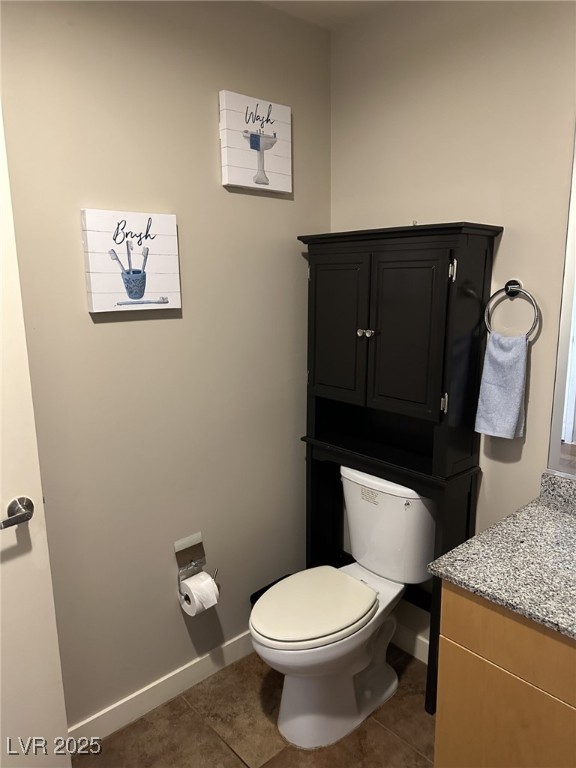 bathroom with vanity, toilet, and tile patterned flooring