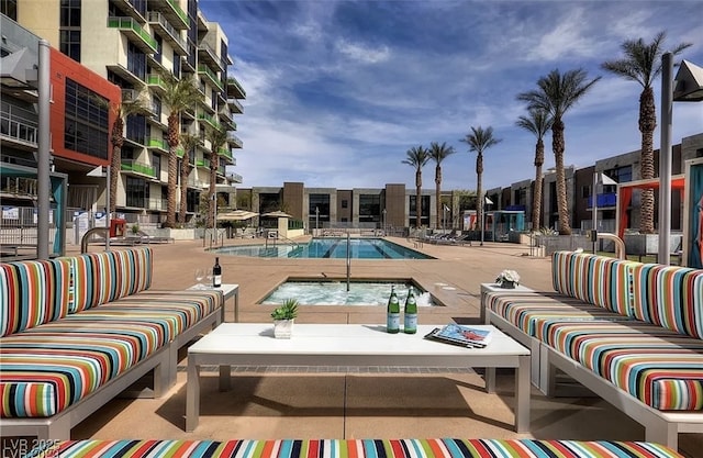 view of pool featuring an outdoor living space and a patio area