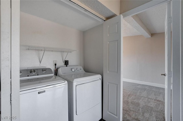 clothes washing area with washing machine and dryer and carpet flooring