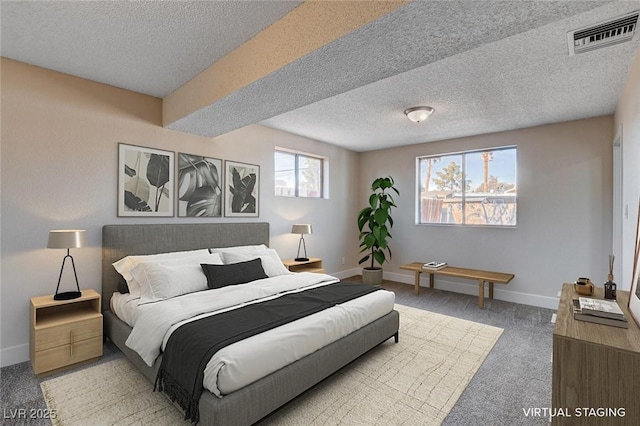 carpeted bedroom featuring a textured ceiling