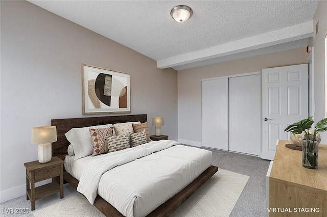 bedroom featuring a closet, carpet, and a textured ceiling