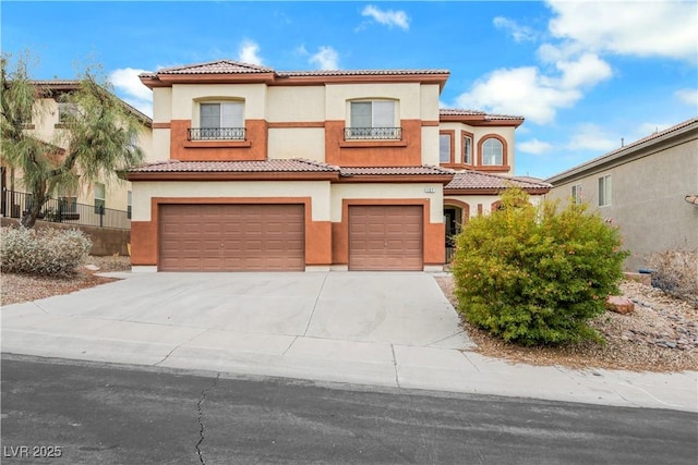 mediterranean / spanish home with a garage