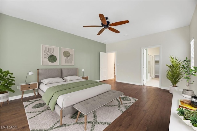 bedroom with ceiling fan, connected bathroom, and dark hardwood / wood-style flooring