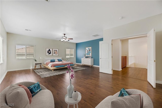 bedroom with dark hardwood / wood-style floors and ceiling fan