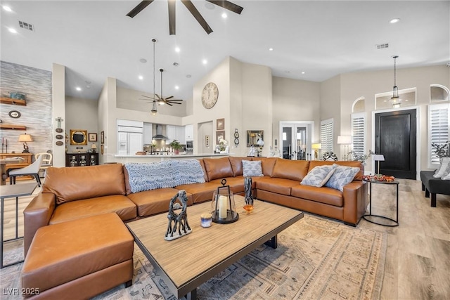 520 Summer Mesa Dr, Las Vegas, NV 89144 - living area featuring high vaulted ceiling, light wood finished floors, a ceiling fan, and visible vents