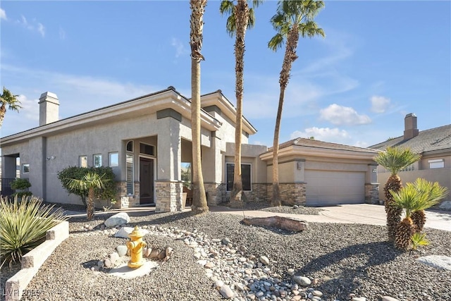 520 Summer Mesa Dr, Las Vegas, NV 89144 - view of front of home with stone siding, concrete driveway, stucco siding, and an attached garage