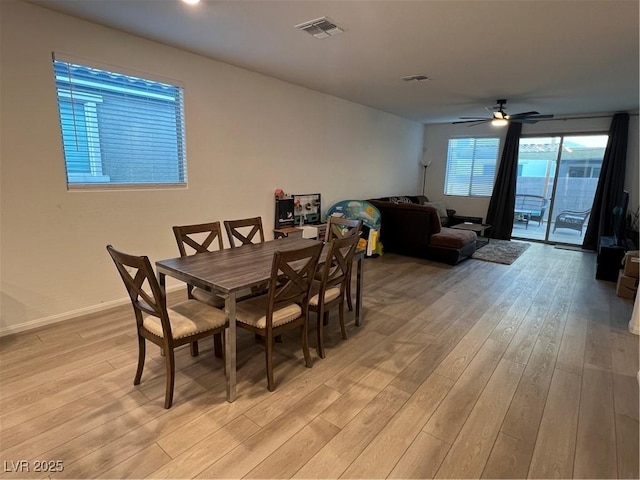 dining space with ceiling fan and light hardwood / wood-style flooring